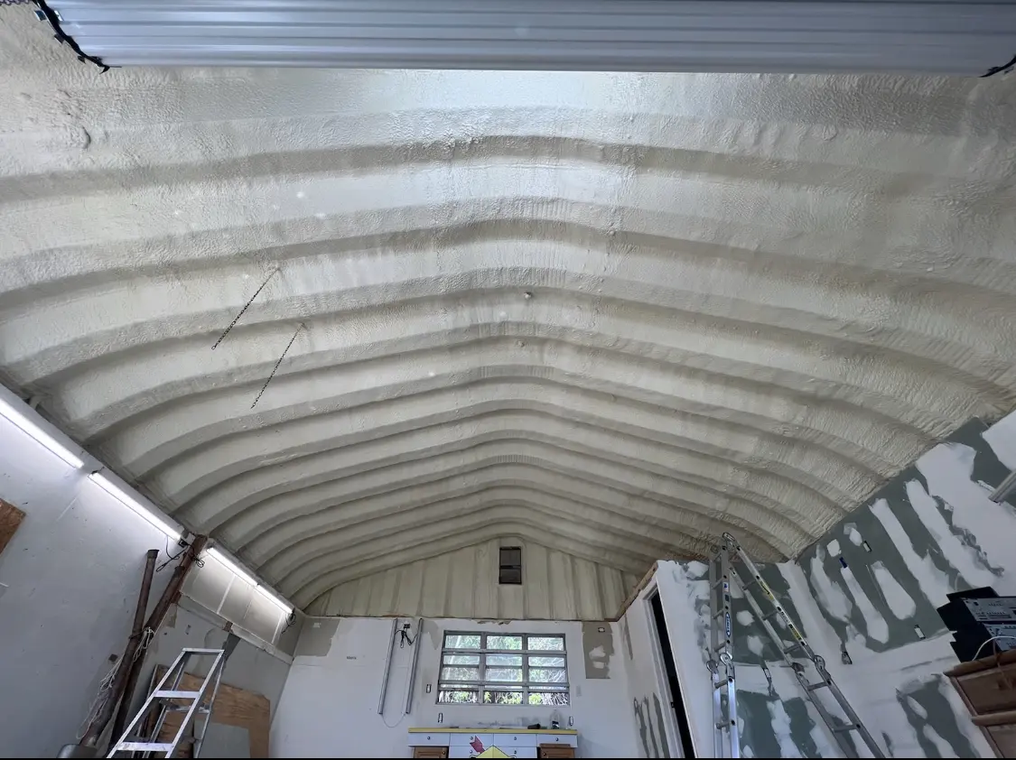 Spray polyurethane foam applied to the underside of a metal roof deck in Senoia